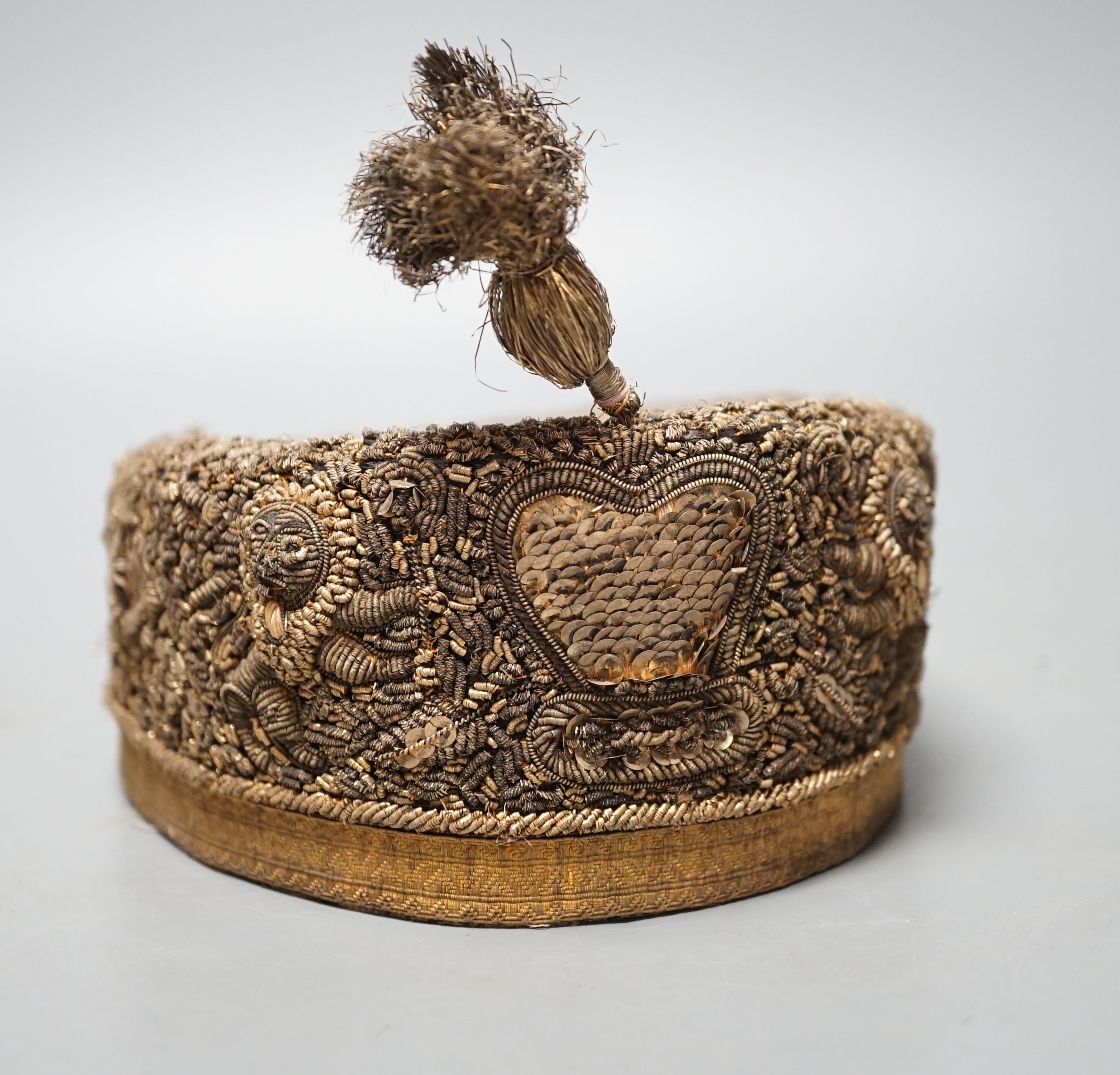 An Indian heavily embroidered cap with sequins and gilt thread 18cm